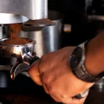 Gemahlener Kaffee wird in eine Siebträgermaschine gefüllt