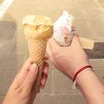 Zwei Hände halten jeweils ein Eis in ihren Händen
