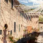 Eine enge, mit Blumen geschmückte Gasse in Valdemossa auf Mallorca, geschmückt mit weißen und gelben Stoffbändern, die sich über den Himmel spannen.