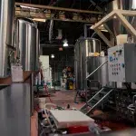 Brauerei von innen mit Stahlfässern und Maschinen