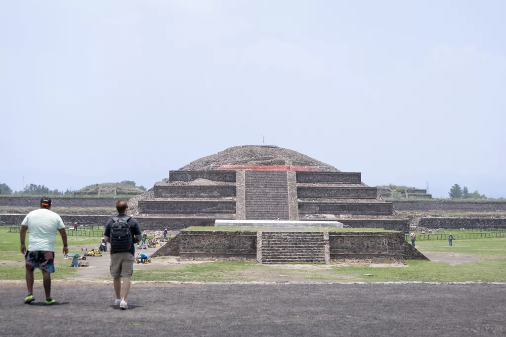 Blick auf die Front des Tempels des Quetzalcóatl mit markanten Steinstufen und kunstvollen Skulpturen in Teotihuacán, Mexiko.