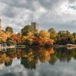 Herbstliche Bäume spiegeln sich im ruhigen Wasser des Nakajima Parks in Sapporo – ein beliebter Ort zum Spazierengehen mitten in der Stadt.