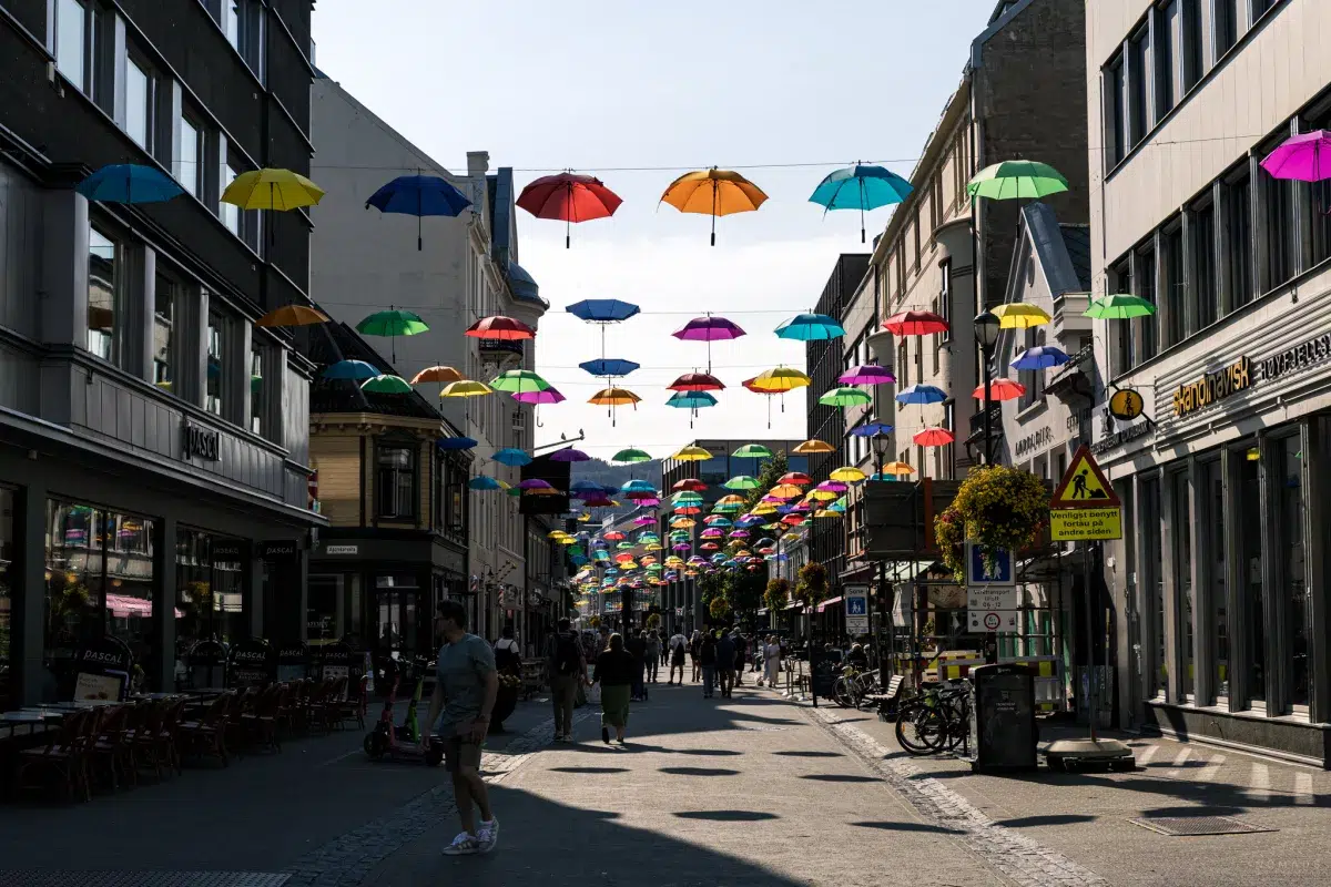 Bunte Regenschirme hängen in einer Gasse in der Innenstadt von Trondheim